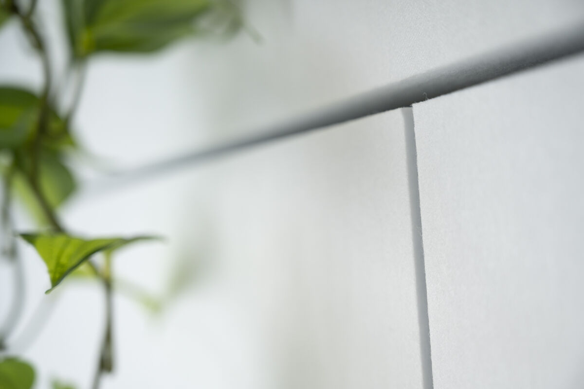 Frameless Custom Cut Nahaufnahme der gefrästen Nut und Fuge in einem weißen rahmenlosen Akustikpaneel